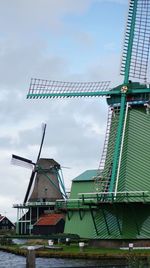 Low angle view of traditional windmill against sky