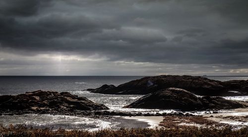 Scenic view of sea against cloudy sky