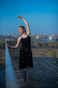 Full length of woman standing against sky