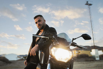 Man riding motorcycle against sky