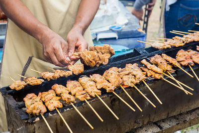 Man preparing food on barbecue grill