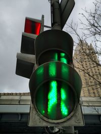 Low angle view of road signal against sky