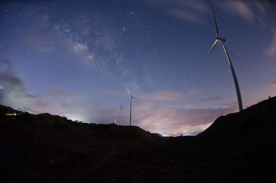 Low angle view of landscape against sky at night