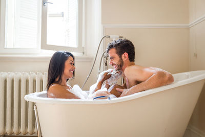 Young couple kissing in bathroom