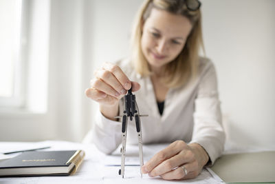 Woman working on table in office