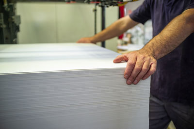 Midsection of man working on table