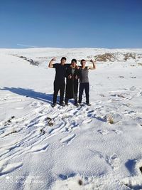 People standing on snow covered land