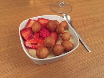 High angle view of strawberries in bowl on table