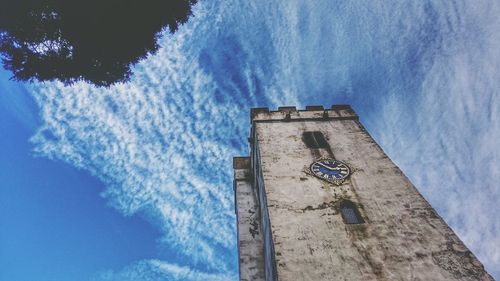 Low angle view of clock tower against sky