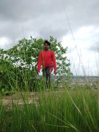 Man standing on field against sky
