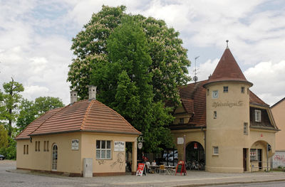 Exterior of building by trees against sky