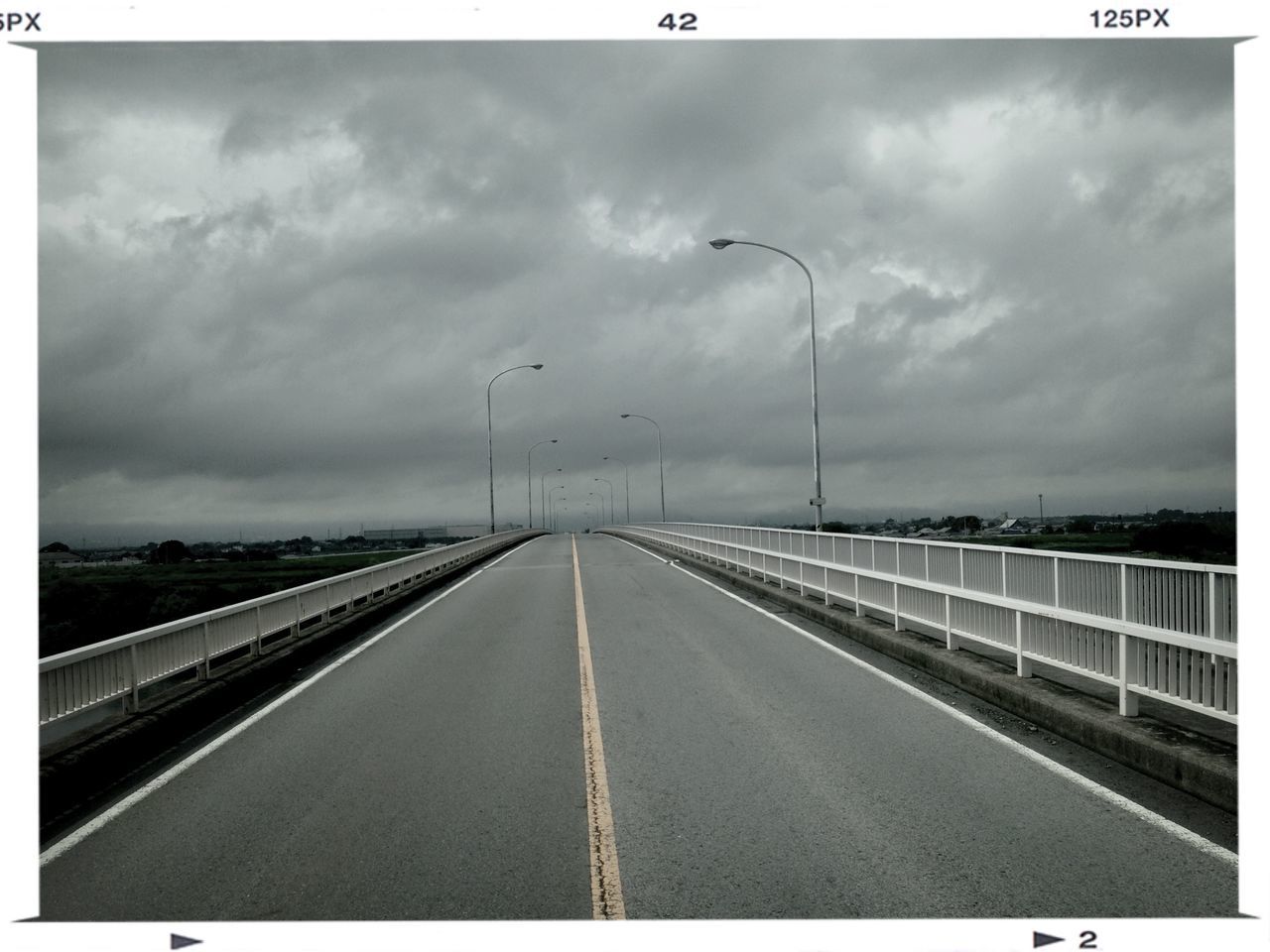 sky, the way forward, diminishing perspective, cloud - sky, cloudy, transfer print, vanishing point, transportation, overcast, auto post production filter, weather, cloud, connection, road, built structure, railing, railroad track, day, outdoors, architecture