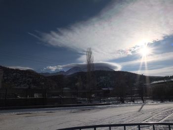 Snow covered landscape against sky