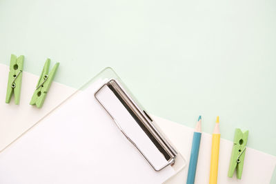 Close-up of colored pencils over white background