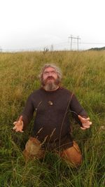 Portrait of man on field against sky