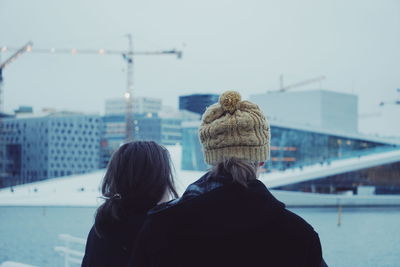 Rear view of women in city during winter