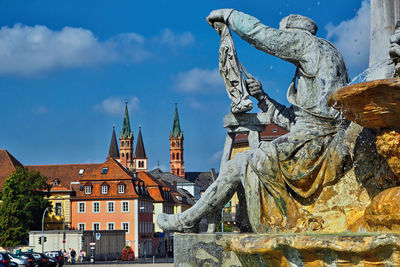 View in the city from würzburg, a old town in germany with several churches and in front a monument