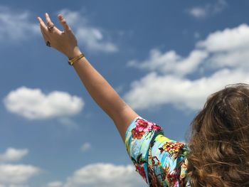 Cropped image of woman hand against sky