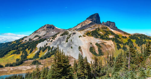 Scenic view of mountains against clear blue sky