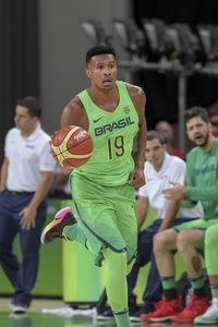 Men playing with basketball on court