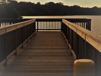 Wooden pier over lake against sky