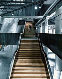 Low angle view of man walking on escalator