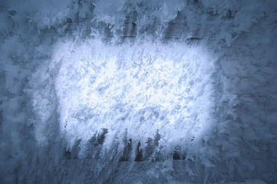 Ice covered window of a frozen house