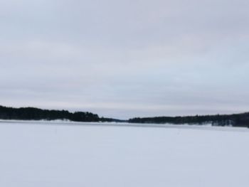 Scenic view of lake against sky during winter