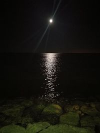 Scenic view of sea against sky at night