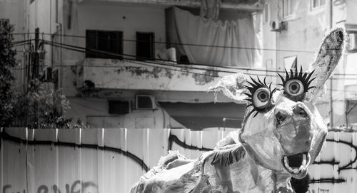 Low angle view of statue against building in city