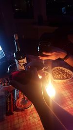 Close-up of hand on illuminated table