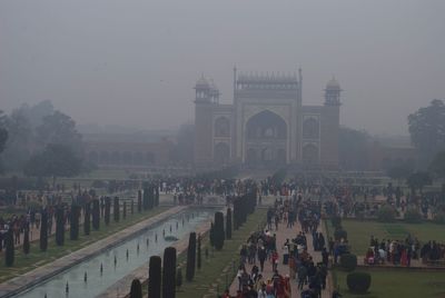 Taj mahal surrounded by fog and tourists