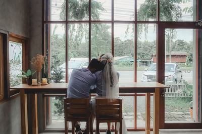 People sitting on table by window