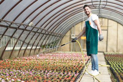 Full length of man standing in greenhouse