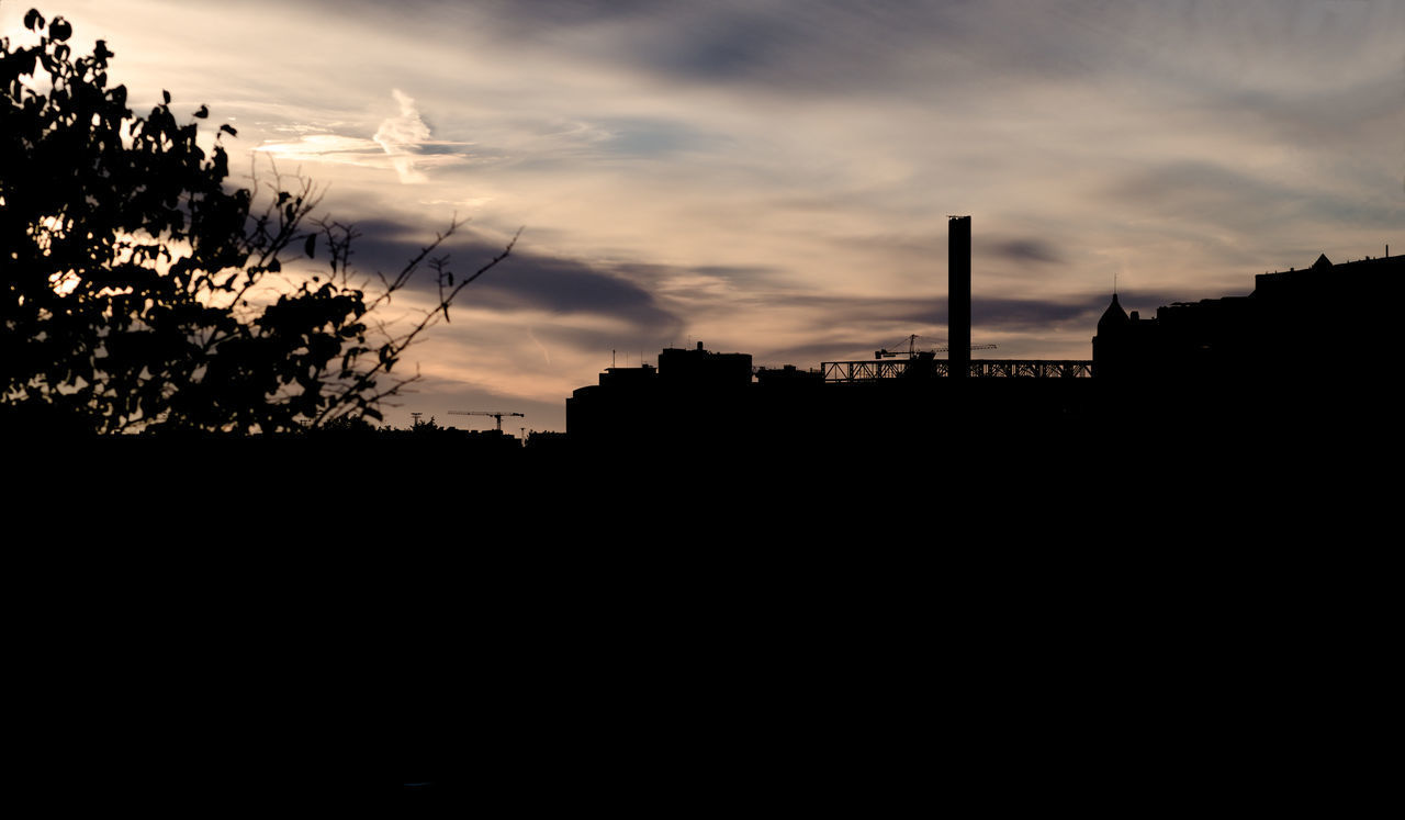 SILHOUETTE BUILDINGS AND TREES AGAINST SKY AT SUNSET