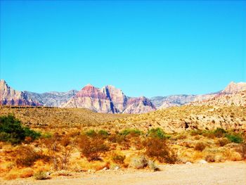 Scenic view of mountains against clear blue sky