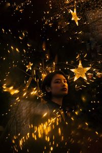 Portrait of man in illuminated christmas lights