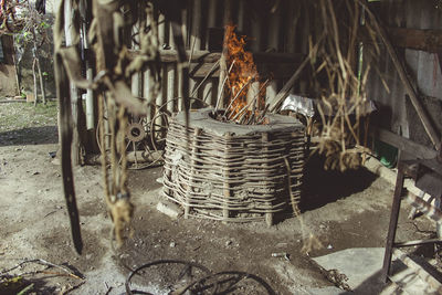 Close-up of wicker basket hanging on metal in field