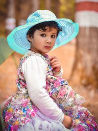 Side view of cute girl wearing hat