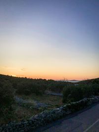 Scenic view of landscape against clear sky during sunset