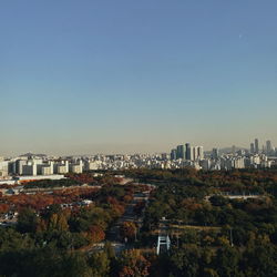 High angle view of buildings against clear blue sky