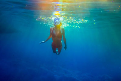 Young woman swimming in sea