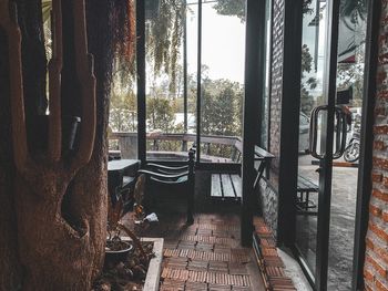 Chairs and table against trees seen through window