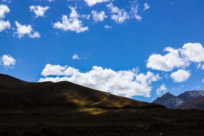 Scenic view of mountains against cloudy sky