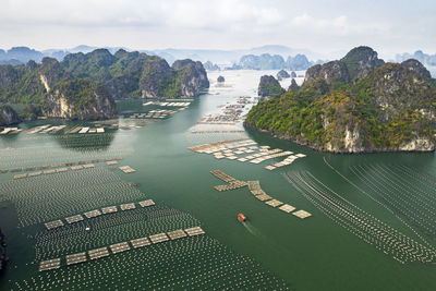 High angle view of sea and mountain against sky