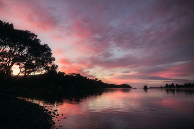 Scenic view of lake against romantic sky at sunset