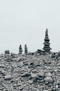 Stone stack on rocks against clear sky