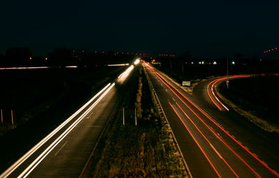 Light trails on road in city at night