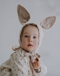 Toddler baby girl in funny hat with ears having fun