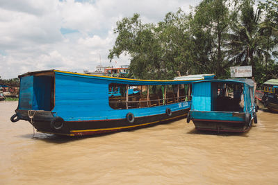 Boats moored on river